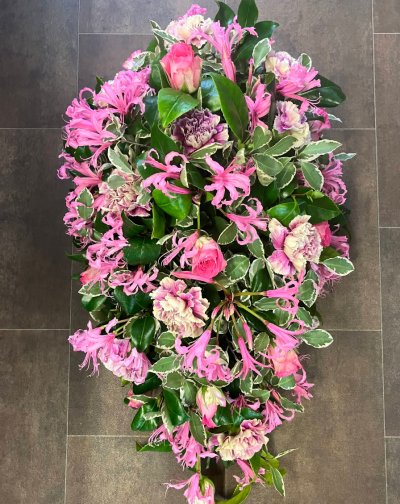 Pink Elegance Spray - A graceful teardrop-shaped funeral tribute designed in rich pink tones with delicate textures and glossy foliage throughout. This elegant arrangement offers a beautiful expression of love, admiration, and remembrance, creating a heartfelt farewell for someone dearly cherished.