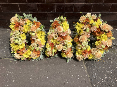 Golden Harvest Letters - Individual floral tribute letters created in warm golden and peach tones with seasonal flowers.