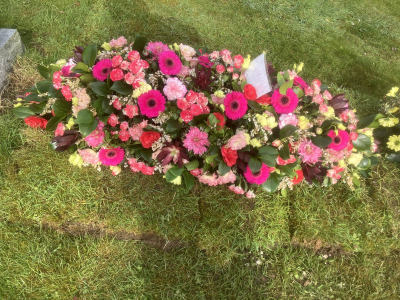Pink Remembrance Spray - A graceful double-ended spray in vibrant pink tones, handcrafted with seasonal flowers and lush foliage to create a heartfelt tribute.