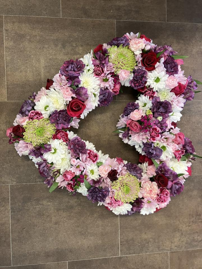 Blush & Plum Open Heart - A beautifully handcrafted open heart tribute in soft pink, plum and white tones, created with seasonal flowers to express love, remembrance and heartfelt sympathy.