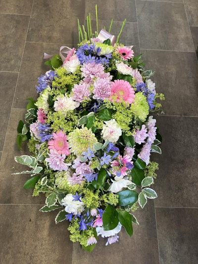 Pastel Tied Sheaf - A beautifully arranged tied sheaf in soft pink, lilac, white and fresh green tones, handcrafted with seasonal flowers for a graceful and heartfelt tribute.