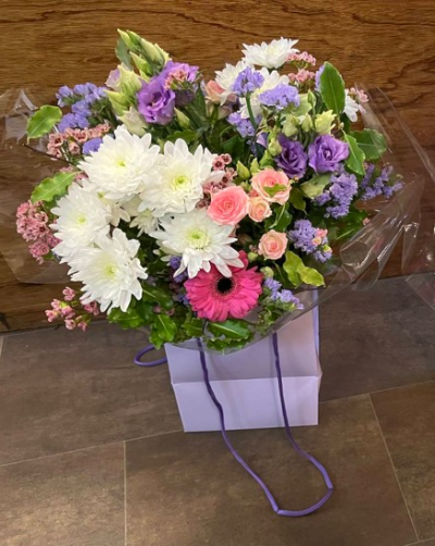 Lavender Garden Gift Bag - A beautifully handcrafted gift bag arrangement in soft lavender, pink and white tones, created with seasonal flowers for a thoughtful gift.