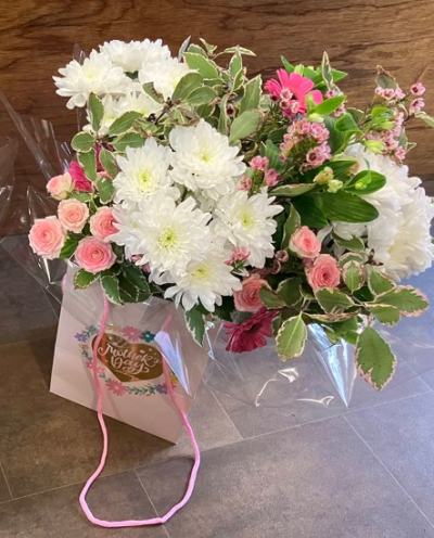Pretty in Pink Gift Bag - A beautifully handcrafted gift bag arrangement in crisp white, soft pink and fresh green tones, created with seasonal flowers for an elegant gift.